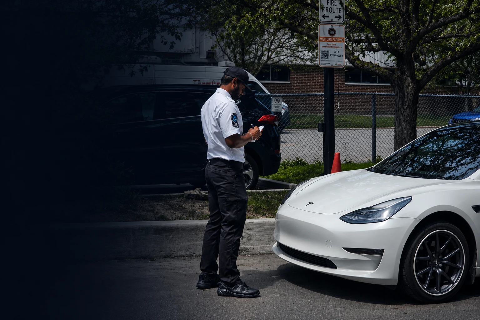 KingsGuard security guard issuing a ticket in a visitor parking lot